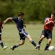 Boys Playing soccer with rules